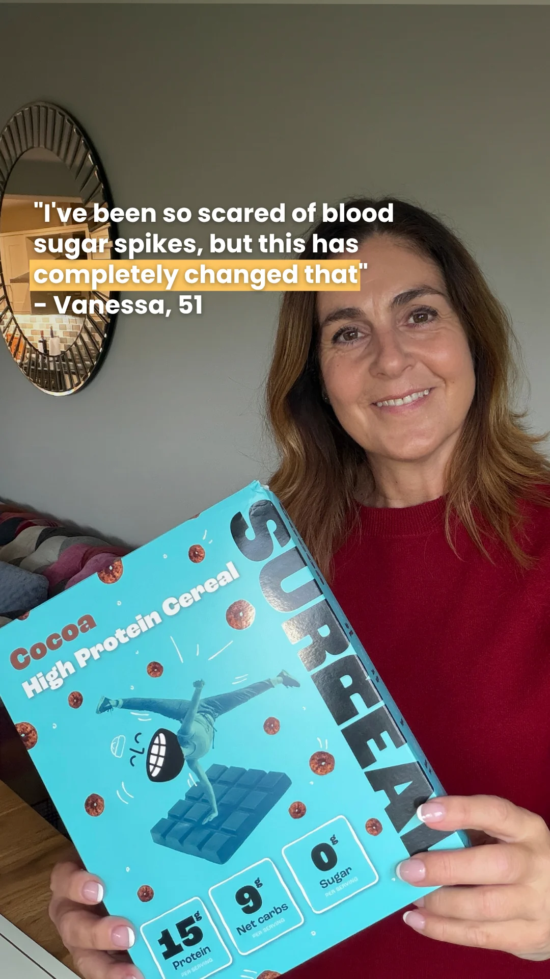 Surreal UGC testimonial ad: a woman at home holds a teal Cocoa High Protein Cereal box with a caption quote about blood sugar spikes from Vanessa, 51